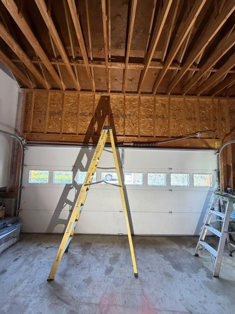 Interior view of a white garage door installation with hardware visible