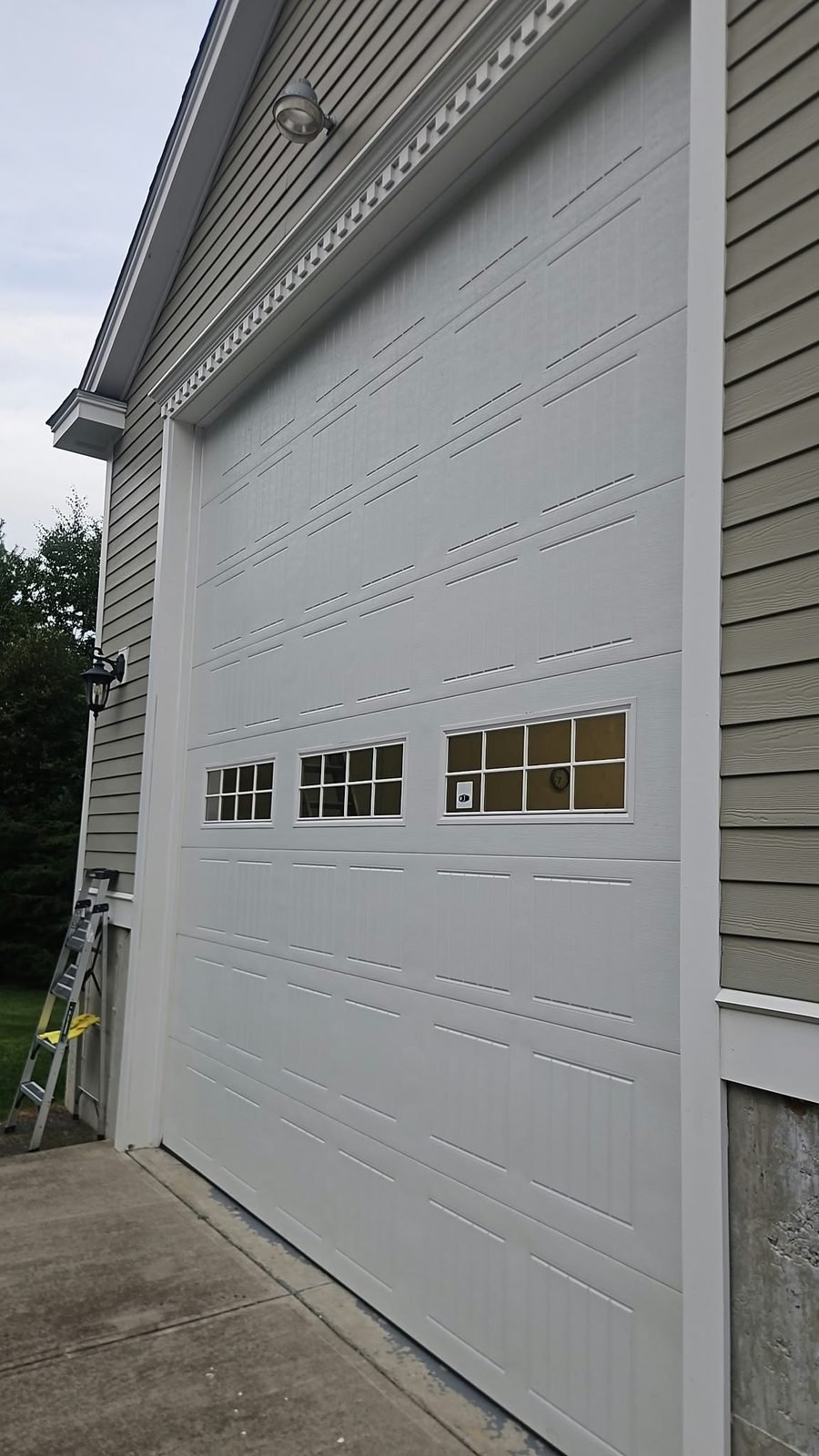 White paneled garage door with window inserts