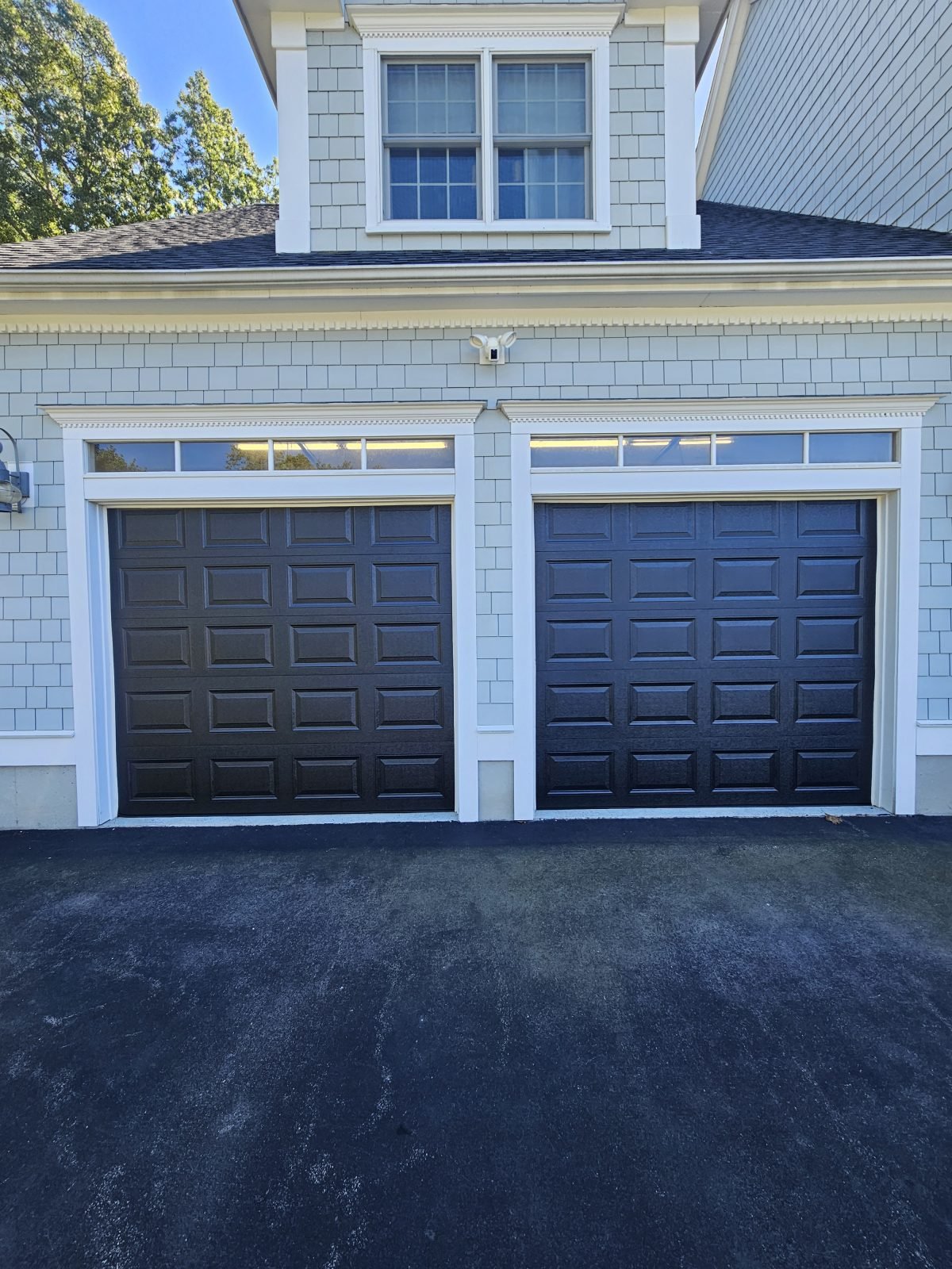 New black raised-panel garage doors installed, Braintree MA