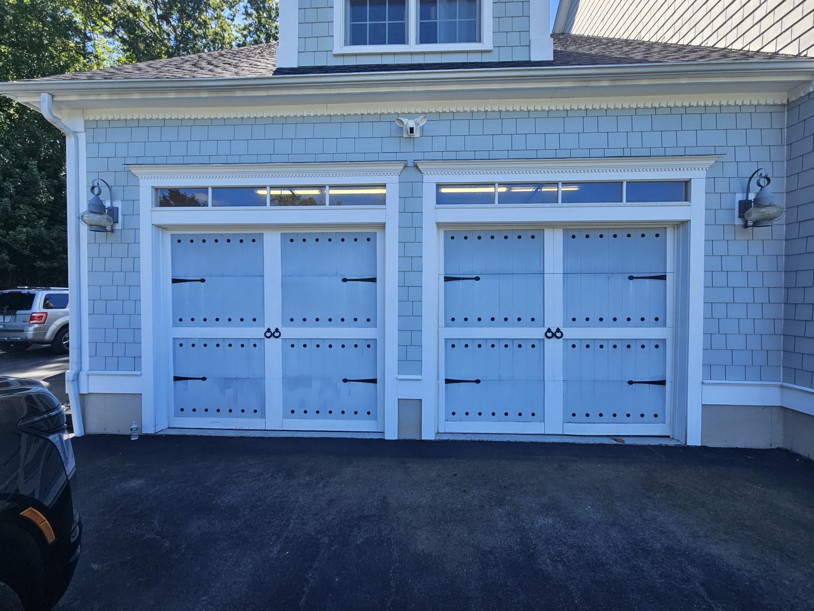 White garage doors with black decorative hardware before replacement, Braintree MA