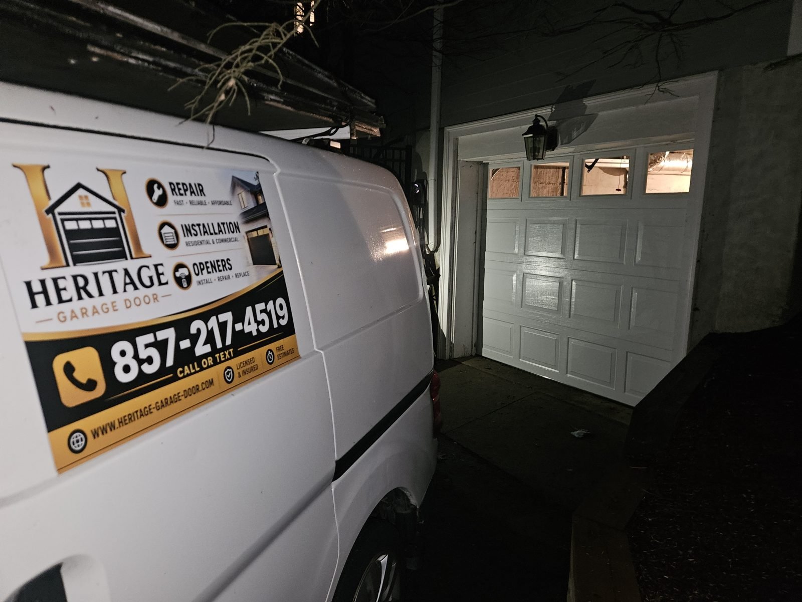 New white raised-panel garage door with windows installed