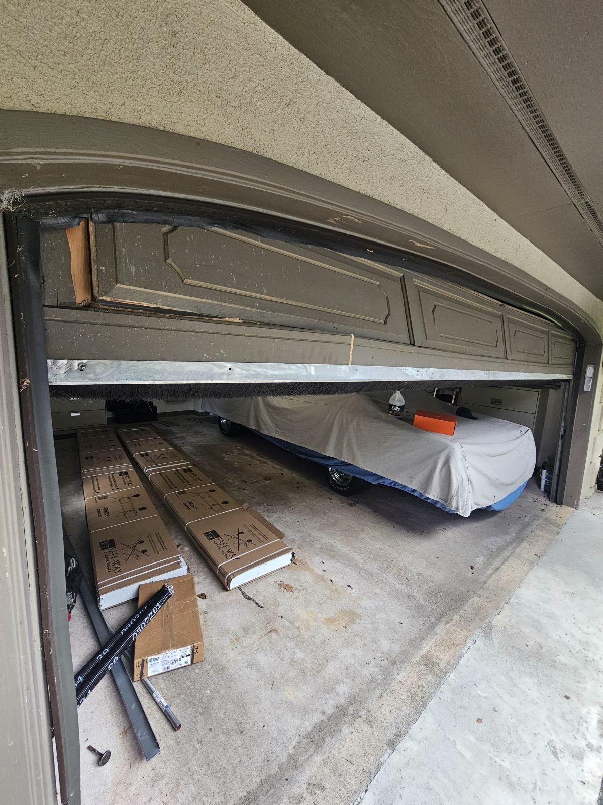 Damaged garage door before replacement in Framingham, MA
